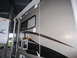 2008 Ford F-450 - An RV camper is shown parked indoors next to another recreational vehicle.