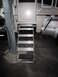 2008 Ford F-450 - Foldable silver steps with black tread are extended from a truck camper.