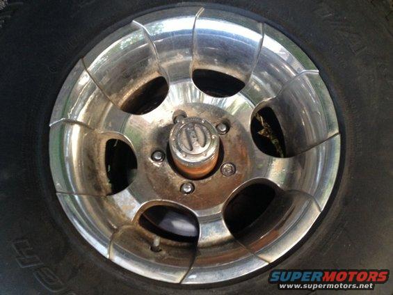 Close-up of a chrome wheel with a black tire and a silver hubcap