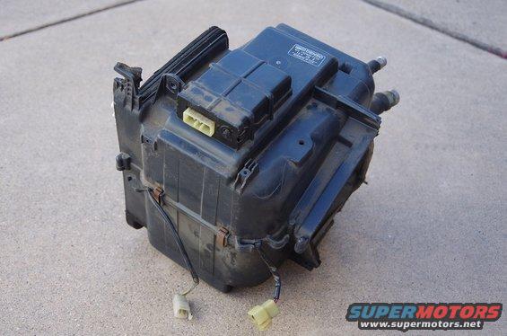 Automotive HVAC blower motor assembly with yellow electrical connectors and wiring
