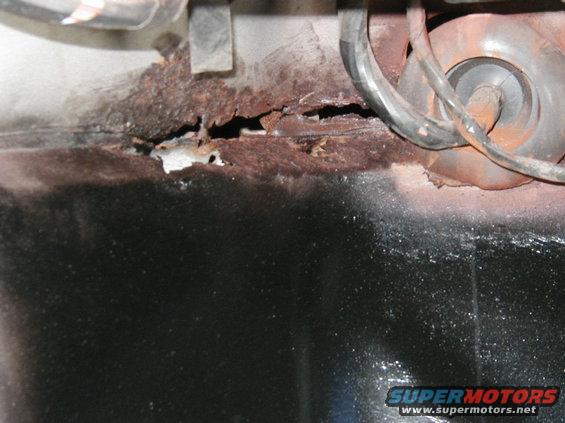 passenger side floor pan holes. i plan on cutting out the rust and migging in some new patches should work