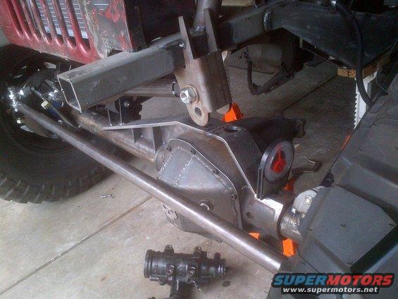 Jeep chassis under construction, showing suspension, differential, and steering components