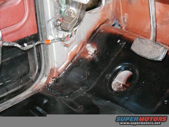 Interior bodywork with pedals and wiring harness visible