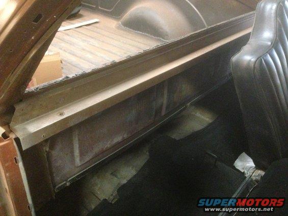 Interior shot of a truck bed with a black seat visible on the right