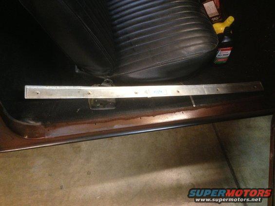 1972 Ford Ranchero interior door sill with visible rust and a black vinyl seat