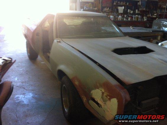 car bodywork in progress, hood scoop visible