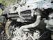 1980 Ford Bronco - Close-up view of heavily soiled engine and radiator parts, obscuring specific vehicle identification.