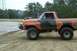 1978 Ford Bronco - Modified 1978 Ford Bronco with custom bumper and roll cage seen off-roading.