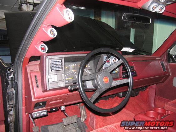 Interior view of a 1990 Chevrolet Silverado 1500 with aftermarket gauges on the A-pillar