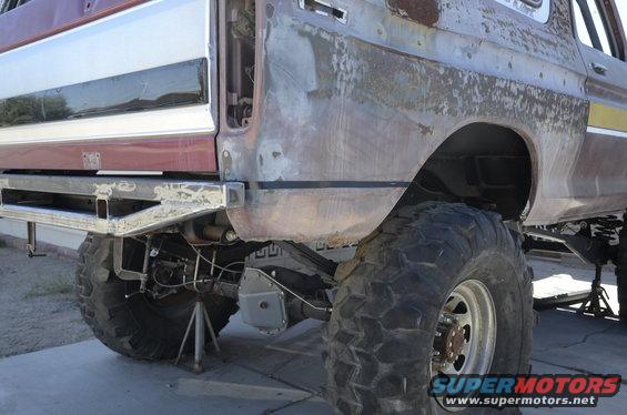 Rear bumper and fender of a lifted truck with large tires