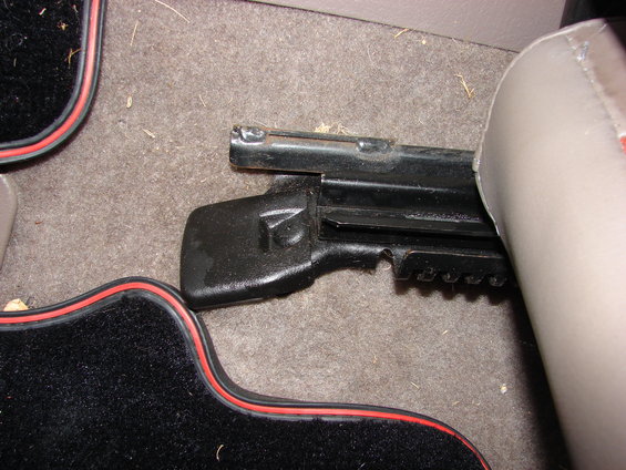 Close-up of a car's seat mounting bracket and part of the seat cushion