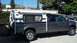 2000 Ford F-250 - A dark gray Ford F-250 Super Duty truck is equipped with a white camper shell.