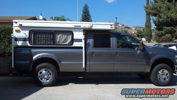Side view of gray pickup truck with camper shell, 2008 model