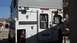 2000 Ford F-250 - The rear of a truck camper is shown, a door, windows, and exterior latches.