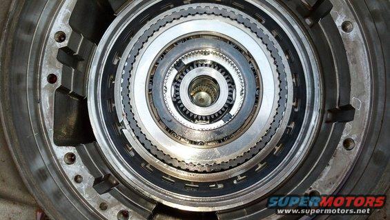 Close-up of a transmission's torque converter clutch assembly with multiple layers of metal plates and gears