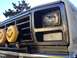 1986 Ford Bronco - This vehicle features a chrome grille and custom smiley face "Daylighter" fog lights mounted on a brush guard.