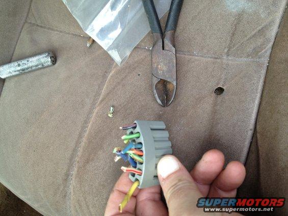 img_1217.jpg That's the connector at the end of the wires.  How's that get back up the tight steering column the wires are snaked down?  It doesent.  You have to cut it off, no way around it.  How does the new one go down the hole?  It doesn't.  You pull the wires out of it and snake only them down the column.  Doing this is much easier than you think.  Save the old connector!!!!  And leave some meat on the wire.  You'll need to put the new wires back in, in the same order.  

Once the connector is cut, pull the wires at the top and pull the whole 9 yards out. 