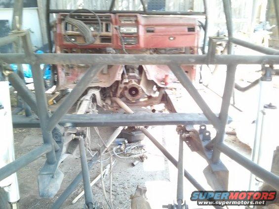 1986 Ford Bronco interior with red dashboard and roll cage