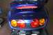 2006 Honda Reflex - The rear of a blue scooter shows its taillight assembly and a Honda emblem.