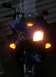 2006 Honda Reflex - A blue scooter is shown at night with its lights illuminated, displaying the Honda logo.