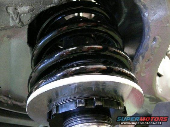 Front suspension coilover shock absorber with black spring and adjustable collar