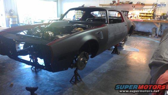 1970s Pontiac Trans Am body on jack stands, engine exposed