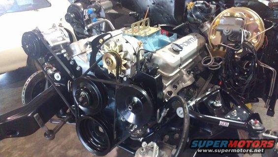 Pontiac V8 engine assembly with "PONTIAC" valve covers, alternator, and pulleys