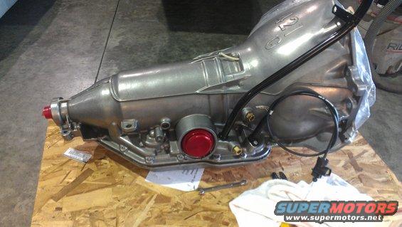 Silver automatic transmission with red accents and black lines