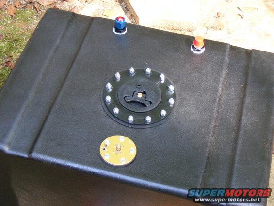 Black fuel tank with a central cap and two fittings on top
