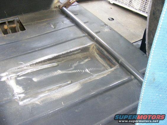 Interior floor with roll bar and blue seat fabric