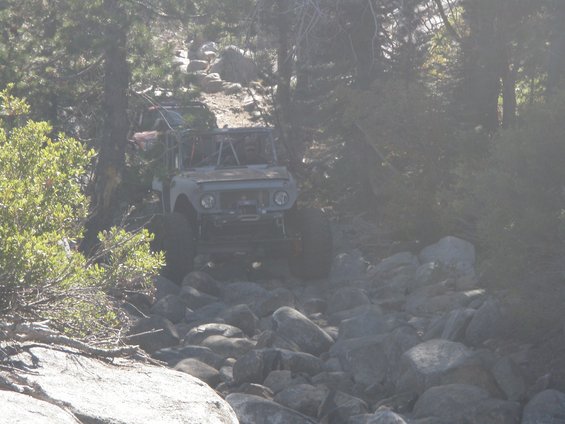 1961 International Scout 800 modified for off-roading, driving on a rocky trail
