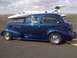 1939 Chevrolet Biscayne - A classic blue sedan is parked on an airport tarmac next to a private jet.