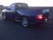 1939 Chevrolet Biscayne - A blue pickup truck is shown from a three-quarter rear view at sunset.