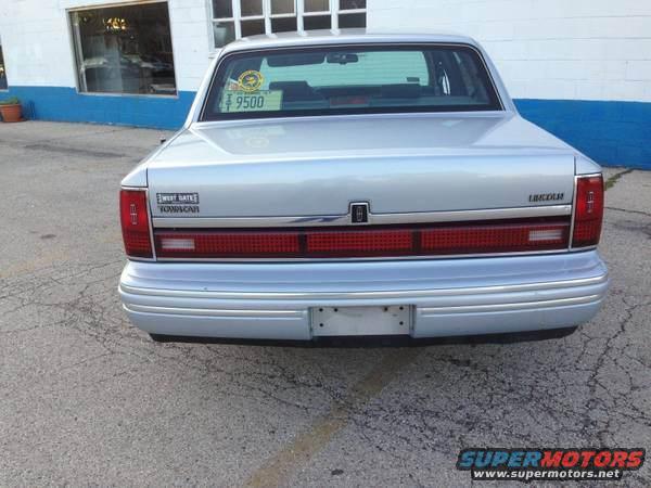 Rear view of a silver 1994 Lincoln Town Car with a "Sweet Bates Iowa Car" sticker