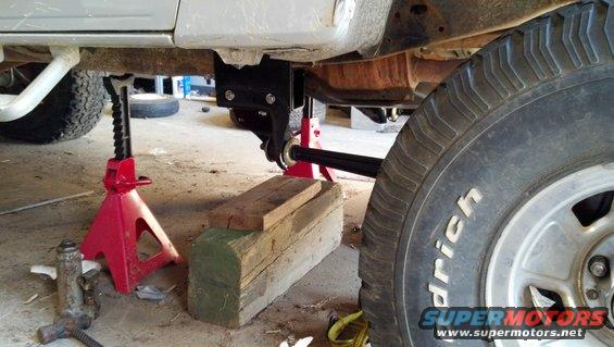 Close-up of truck undercarriage with jack stands and wooden blocks