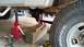 1996 Ford F-150 - Undercarriage view of a truck supported by jack stands and wooden blocks, indicating maintenance or repair work.