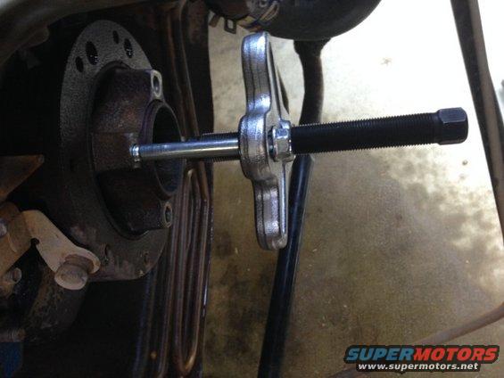 Timing chain cover with puller tool attached