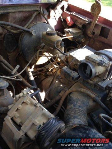 engine bay with brake booster, master cylinder, and air intake parts