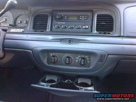 2001 Ford Crown Victoria interior dashboard with radio, climate controls, and cup holders