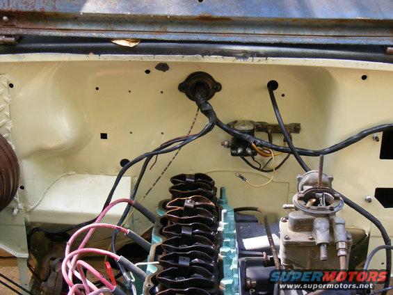 Engine bay showing carburetor, valve cover, wiring, and firewall. Supermotors.net logo visible