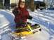 1986 Ford Bronco - Child enjoys a snowy day on a yellow snowmobile.