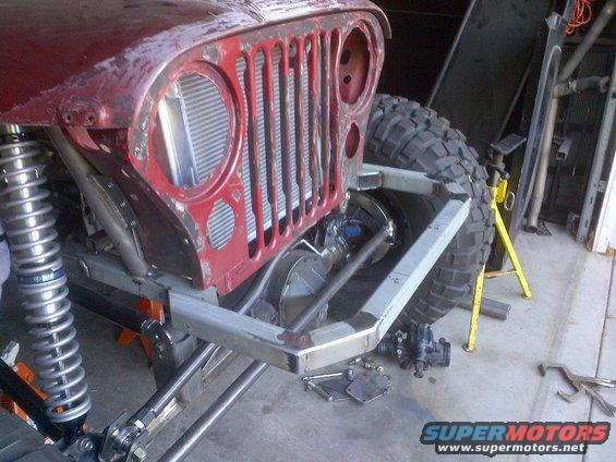 Jeep CJ front end with custom bumper and suspension, radiator visible behind grille