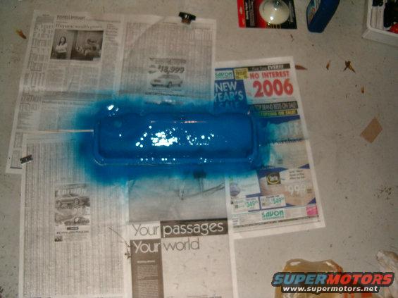 Blue painted car part on newspapers with 2006 sale ad