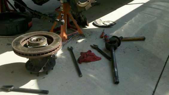 Brake rotor assembly and steering linkage parts on concrete floor