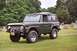 1976 Ford Bronco - This 1976 Ford Bronco is seen in a three-quarter front view, parked on a grassy area with gravestones in the background.