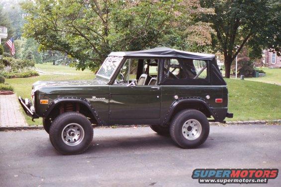 Dark green 1976 Ford Bronco, side view, black soft top
