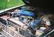 1976 Ford Bronco - The engine bay of a 1976 Ford Bronco is visible, its V8 engine components.