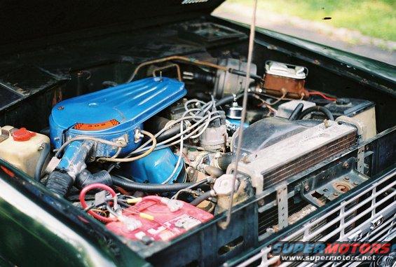 1976 Ford Bronco engine bay with blue air cleaner and red battery