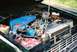 1976 Ford Bronco - The engine bay of a 1976 Ford Bronco, a blue air cleaner assembly and a red battery.