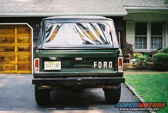 Green 1976 Ford Bronco rear view with soft top and New York license plate